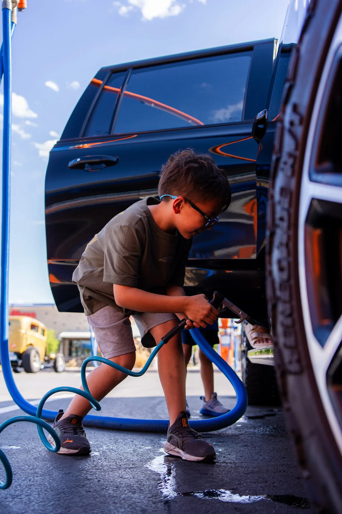 Young Wash Fox customer vacuuming the family car