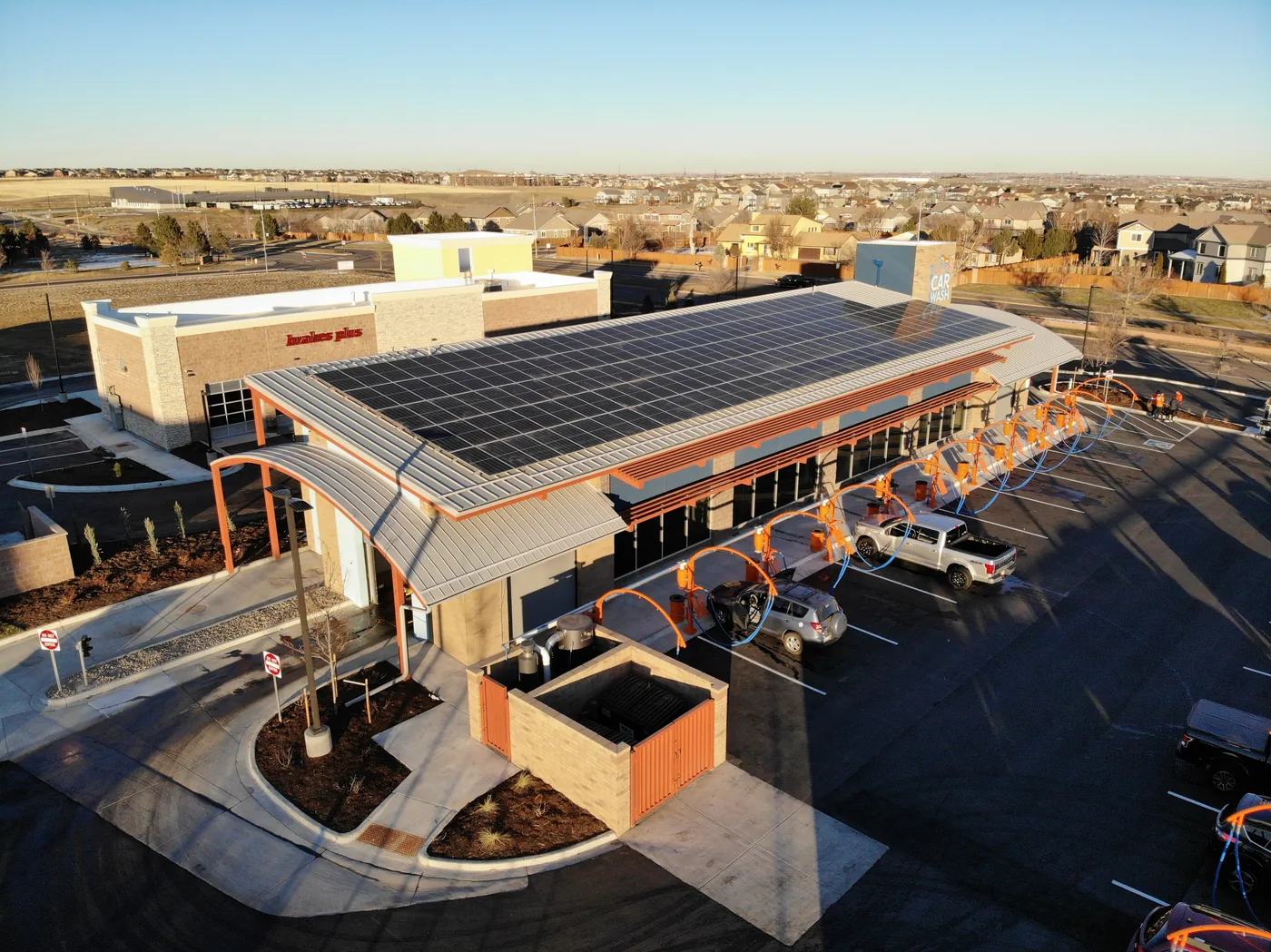 Aerial view of a Wash Fox car wash with rooftop solar panels in Colorado